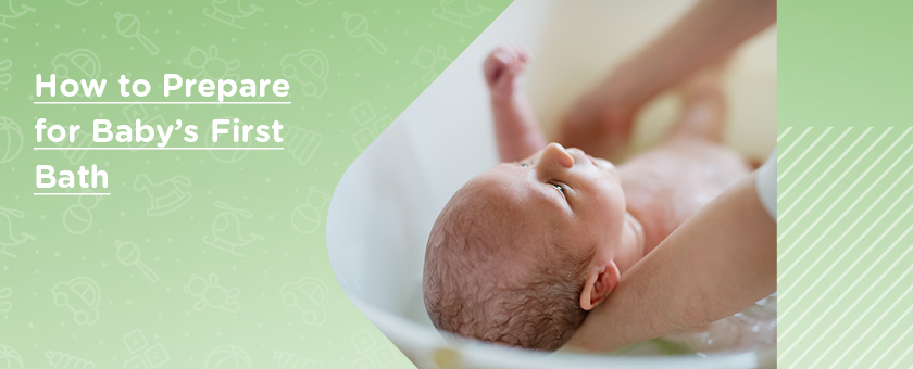 Newborn baby in baby bath whilst being held by parent